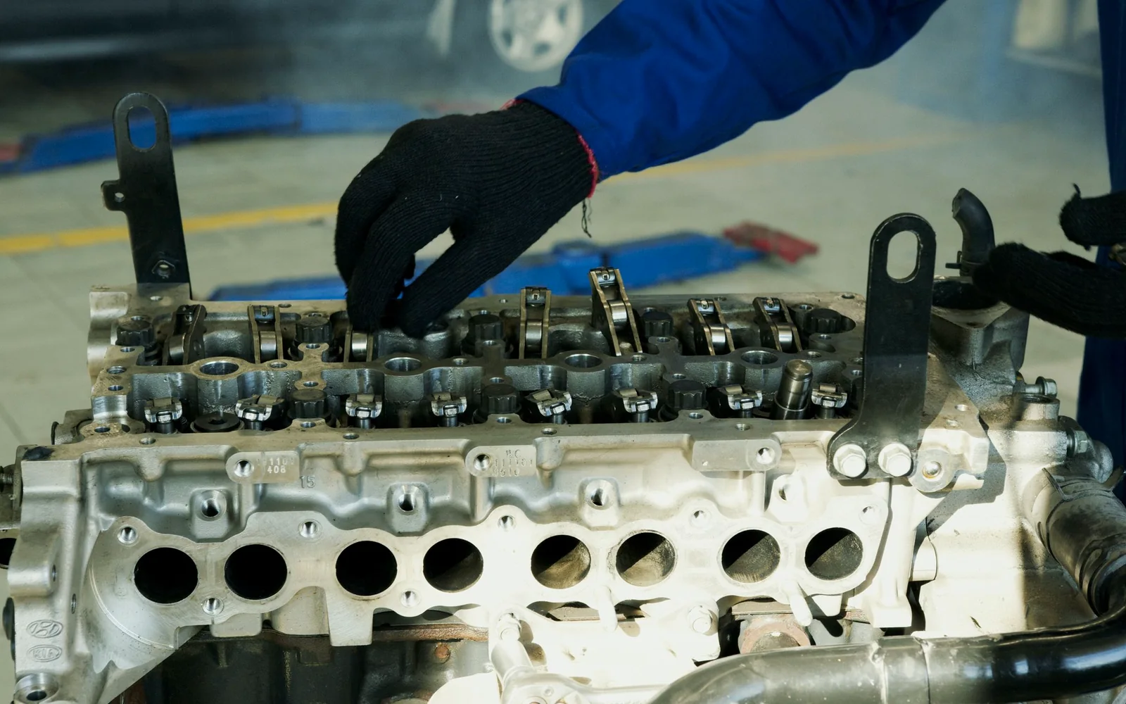 Technician servicing a diesel engine cylinder head
