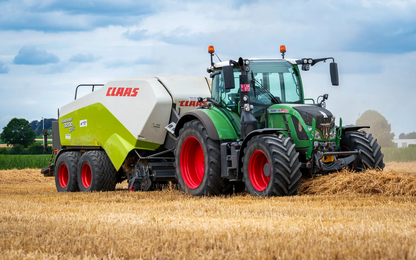 Modern agricultural tractor and baler representing MEC equipment supply